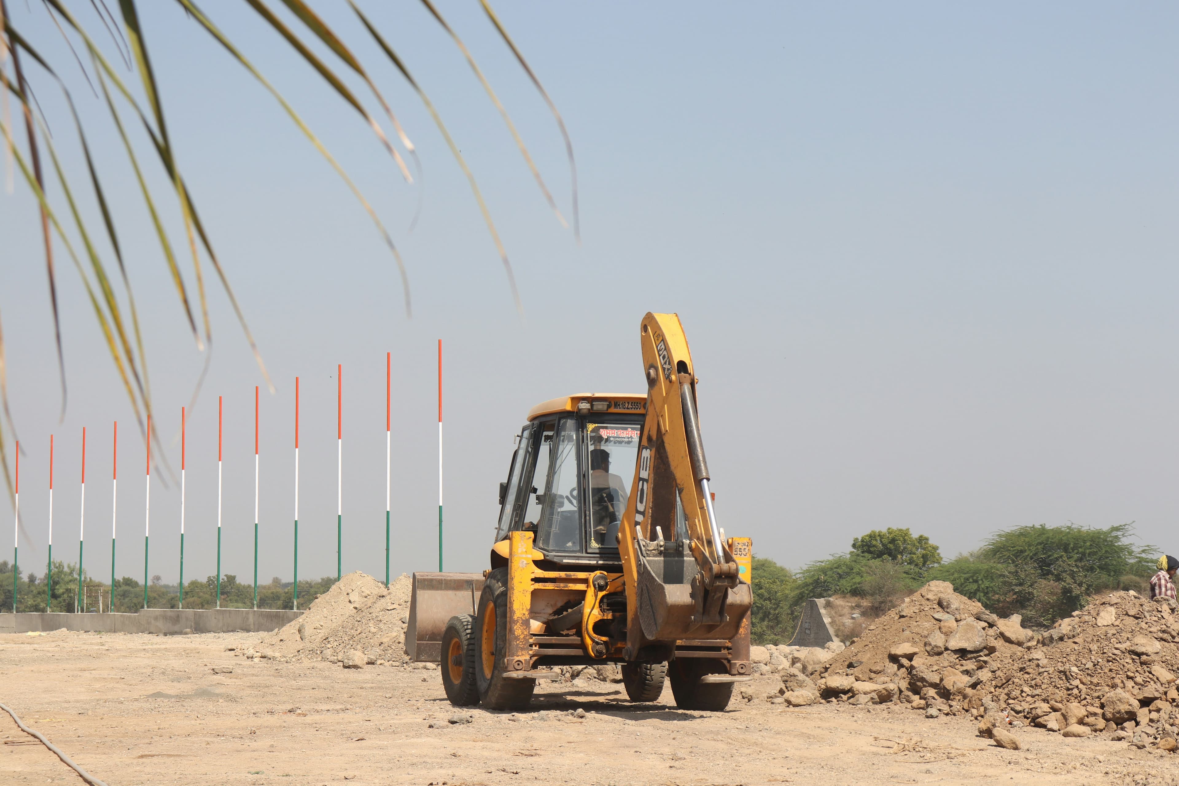 JCB backhoe loader at a construction site in Telangana